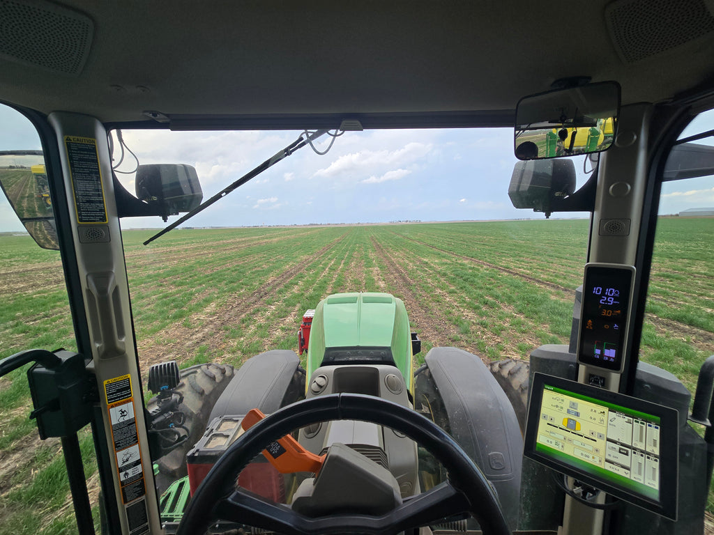 Tractor's cabin view with a field in the background